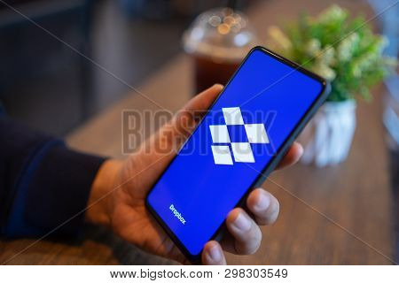 Chiang Mai, Thailand - Mar. 24,2019: Man Holding Xiaomi Mi Mix 3 With Dropbox On Screen.dropbox Is A