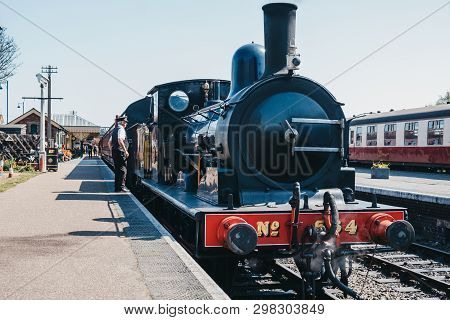 Sheringham, Uk - April 21, 2019: Conductor Standing By The Cab Of The Poppy Line Train, Also Known A