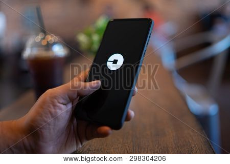 Chiang Mai, Thailand - Mar. 24,2019: Man Holding Xiaomi Mi Mix 3 With Uber Apps. Uber Is Smartphone 
