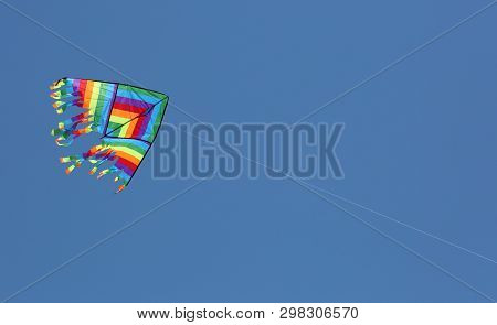Multcolored Kite On The Blue Sky With Vivid Colors
