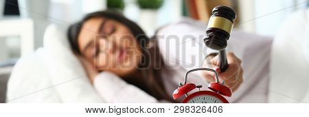 Sleepy Young Woman Portrait With One Opened Eye Trying Kill Alarm Clock. Early Wake Up Not Getting E