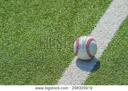 White Ball For Playing Baseball On The Grass Background