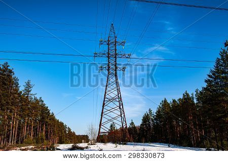 Electrical High Voltage Power Line In The Forest Lsndscape In Spring