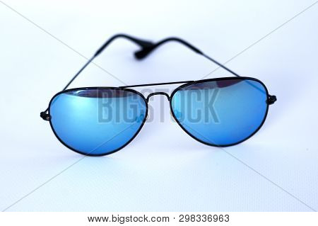 Blue Mirrored Sunglasses With Anti-reflective Coating And Uv Protection On A White Background. Close