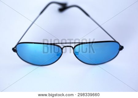 Blue Mirrored Sunglasses With Anti-reflective Coating And Uv Protection On A White Background. Close