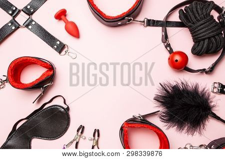 Set Of Erotic Toys For Bdsm. The Game Of Sexual Slavery With Handcuffs, Whip, Gag And Leather Straps