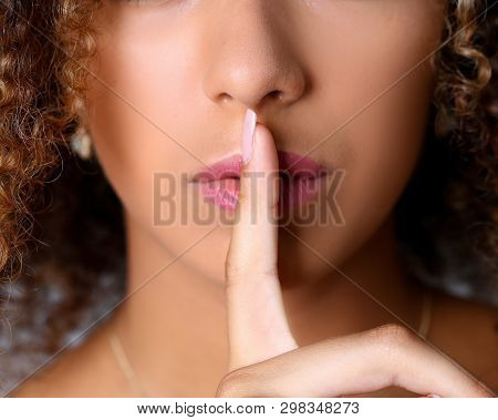 Close-up Portrait Of Perfectly Cut Womans Lips. Lady Posing In Studio. Model Touching Mouth And Show