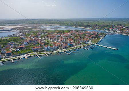 Aerial View Of City Of Nin. Summer Time In Dalmatia Region Of Croatia. Coastline And Turquoise Water