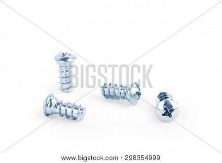 Four Small Screws On A White Background