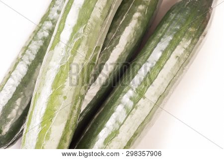 Bunch Of Cucumber Wrapped In Plastic Films, Isolated On White Background
