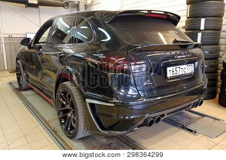 Moscow, Russia - April 29, 2019: Exclusive Black Porsche Cayenne Gts On Suspension Check Stand In Se
