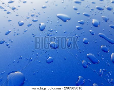 Drops Of Rainwater On Blue Metal Background After Nanoceramics Polishing Technology Closeup