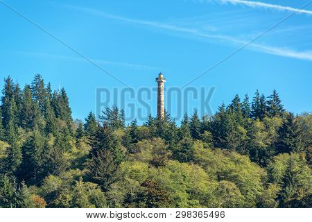 View Of The Astoria Column Rising Above A Forest In Astoria, Oregon