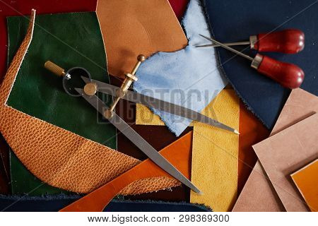 Background Image Of Leather Cuts And Tools Scattered On Table In Tanners Workshop, Copy Space