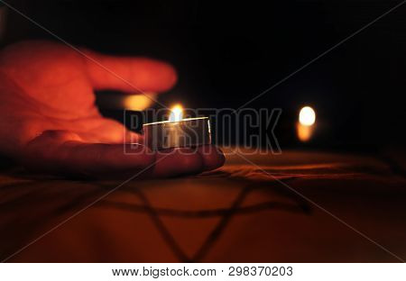 Candles Burning Over The Star Of David In Memory Of The Dead.