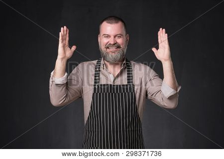 Mature Bearded Man In Apron Bragging About The Big Size Of Something.