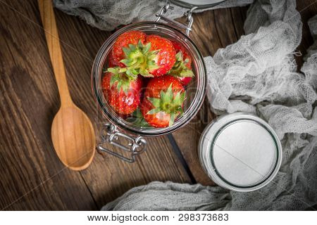 Strawberry In Jar On Wooden Background.