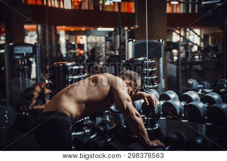 Tired Guy Bodybuilder Bowed His Head In The Gym Because Lack Of Strength And Energy. Athletic Man Wa
