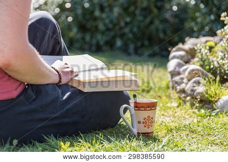 Person Reads A Book Relaxed In The Garden - Rest While Reading
