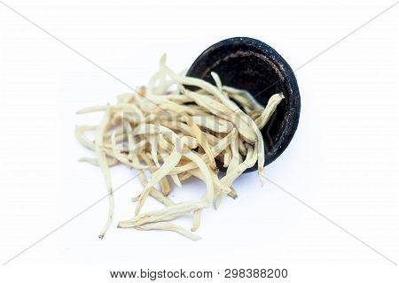 Close Up Of Popular Indian & Asian Ayurvedic Herb Isolated On White In A Clay Bowl I.e. Musli Or Saf