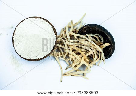 Popular Indian & Asian Ayurvedic Herb Isolated On White In A Clay Bowl I.e. Musli Or Safed Musli Or