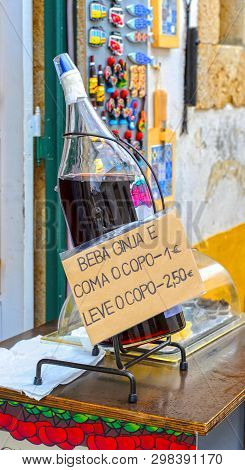 Obidos, Portugal - Aril 2018: Traditional Ginja - Sour Cherry Liqueur - On Sale In The Old Town Stre