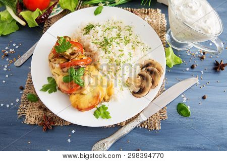 Chicken Fillet Baked In Cheese With Rice And Vegetables. Fired Cordon Bleu Chicken Served With Rice 