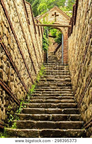 Monastery Of St. Nino At Bodbe, Georgia. Stone Stairs And Stone Arch After Rain.