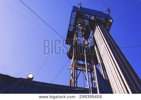 Oil And Gas Drilling Rig Onshore Dessert With Dramatic Cloudscape. Oil Drilling Rig Operation On The