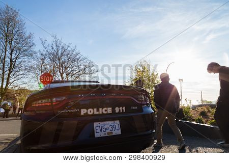 Vancouver, Bc, Canada - Apr 20, 2019: 420 Festival Goers Walk Past A Vpd Car In English Bay, Vancouv