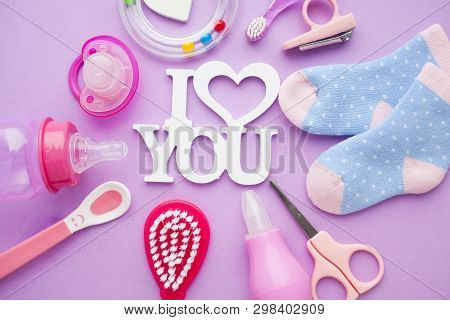 Newborn Baby Story. Strow Heart And Childrens Toys, Scissors, Baby Bottle, Nipple, Hairbrush On Viol