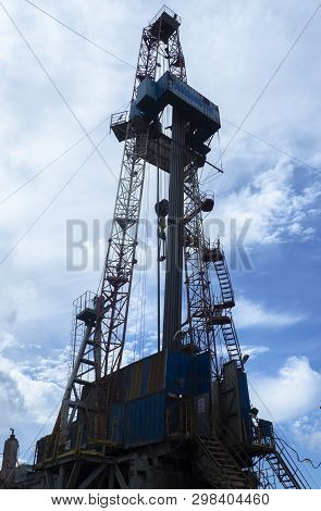Oil And Gas Drilling Rig Onshore Dessert With Dramatic Cloudscape. Oil Drilling Rig Operation On The
