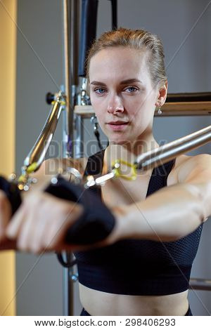 Gym Woman Pilates Stretching Sport In Reformer Bed Instructor Girl. Selective Focus On Hands