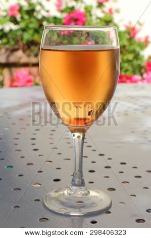 Glass Of Kir For Aperitif On A Metal Table In A Garden