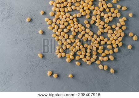 Close Up Shot Of Dry Chickpeas On Grey Background. Raw Vegetarian Food. Healthy Dieting Concept. Nat