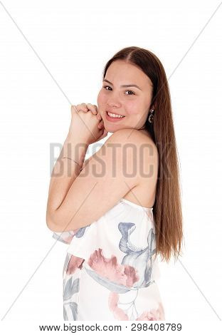 A Lovely Teenager Girl Standing In Profil Waist Up In A Pastel Sommer Dress
With Hands Folted On Her
