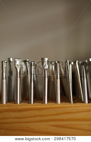 Extreme Close Up Of Leatherworking Tools On Stand In Atelier Workshop, Copy Space