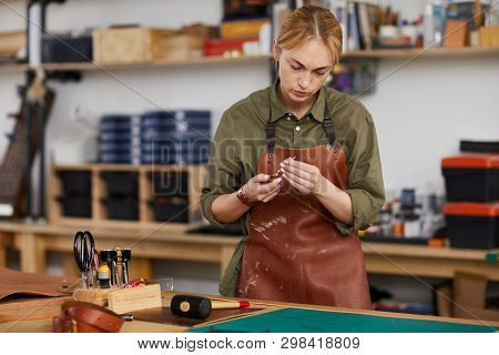 Waist Up Portrait Of Female Artisan Doing Leatherwork In Tannery, Copy Space
