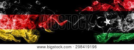 Germany Vs Libya, Libyan Smoky Mystic Flags Placed Side By Side. Thick Colored Silky Smoke Flags Of 
