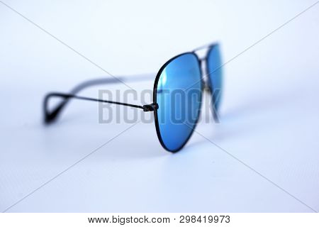 Blue Mirrored Sunglasses With Anti-reflective Coating And Uv Protection On A White Background. Close