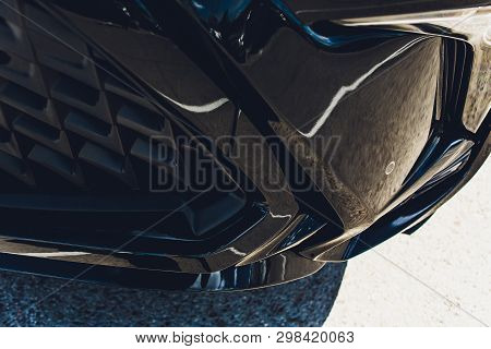 Close Up Of A Luxury Sportive Car With Four Exhaust Pipe And Bumper Realized In Real Carbon Fiber.