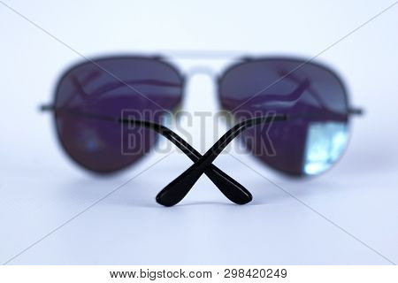 Blue Mirrored Sunglasses With Anti-reflective Coating And Uv Protection On A White Background. Close
