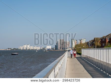 London, England - 21 April 2019: Walkers On The Thames Path National Trail Near Woolwich