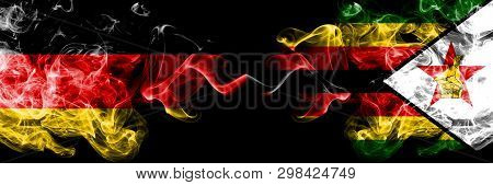 Germany Vs Zimbabwe, Zimbabwean Smoky Mystic Flags Placed Side By Side. Thick Colored Silky Smoke Fl