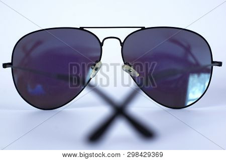 Blue Mirrored Sunglasses With Anti-reflective Coating And Uv Protection On A White Background. Close