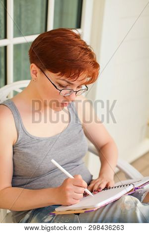 Pondering Attractive Caucasian Woman With Pen In Hand Thinking On Plans And Writing List To Do In No