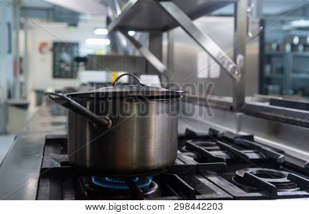 A Stewpot Getting Cooked On Stove In A Restaurant Kitchen