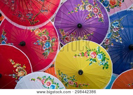 Colorful Handmade Paper Umbrella With Flower Painting. Popular And Famous Thai Handicraft And Souven