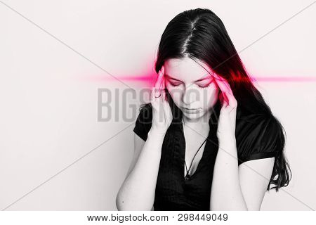 Young Woman Is Suffering From A Headache. Portrait Of A Girl With Pain Points On Her Head. Migraines