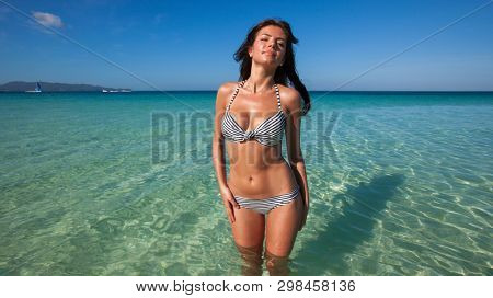 Beautiful giel in bikini in clear sea water, relaxing eyes closed, summer holiday, nature outdoors, exotic travel recreation lifestyle.